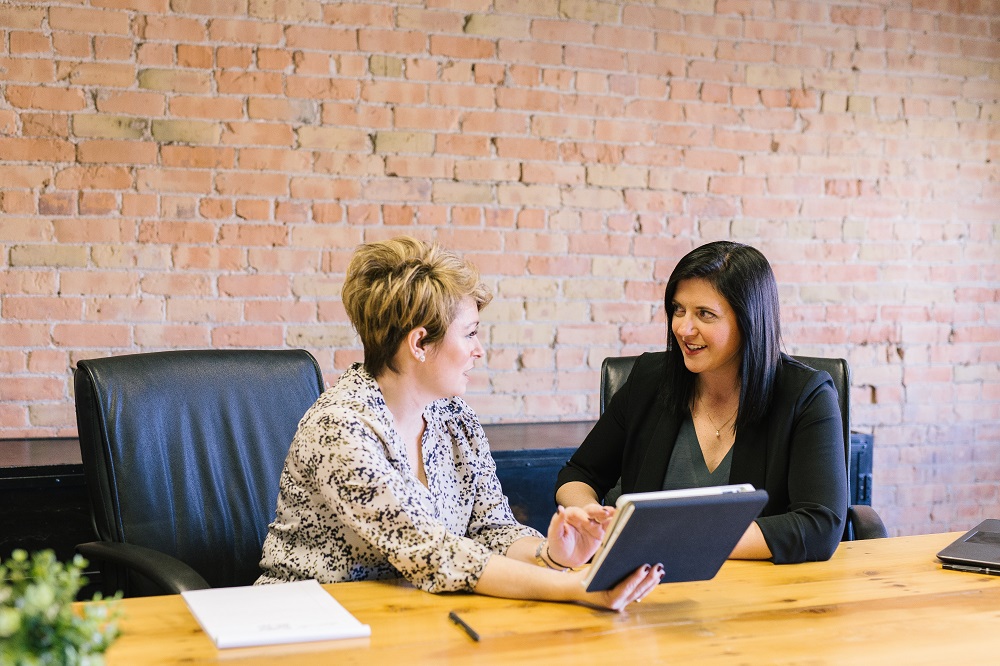 two women, in an office setting